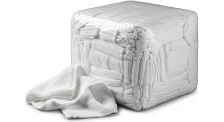 A large, tightly packed cube of white towelling rags with one towel partially pulled out and draped over the side. The towels are soft and absorbent making them perfect for use in the cleaning industry.